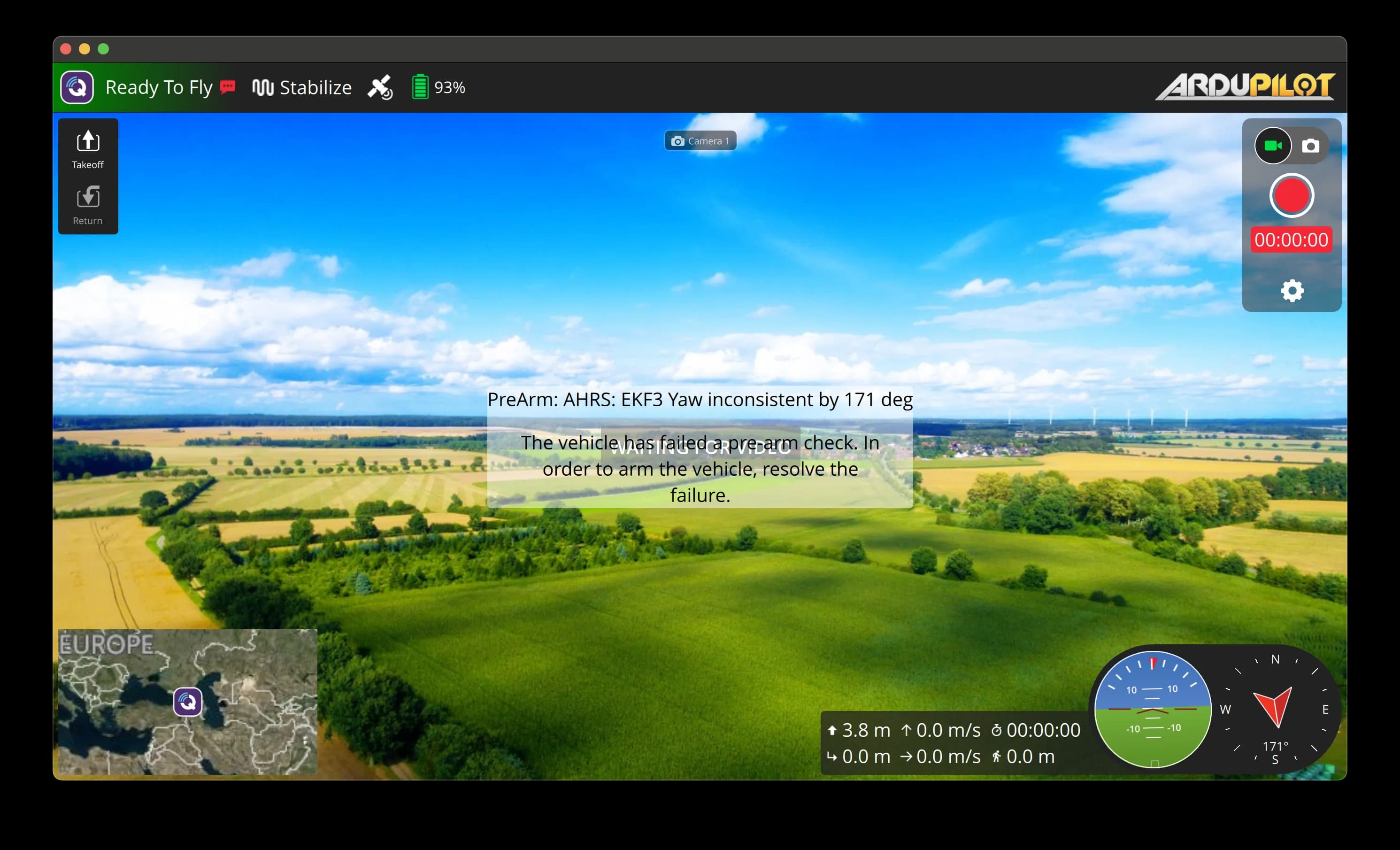 QGroundControl flight view with a full-screen live aerial video of fields, a 'Ready To Fly' status bar, mini-map, attitude indicator and compass.